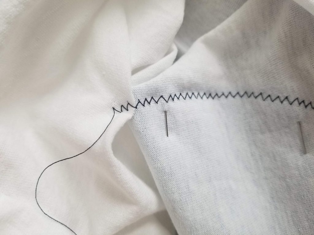 photo of sewing error with stitch sewn through back of shirt, easily fixed with a seam ripper