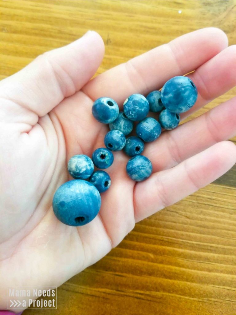 blue colorwashed beads in a hand