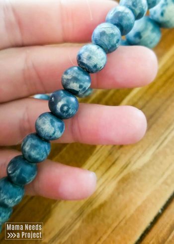 colorwashed wooden beads in a hand