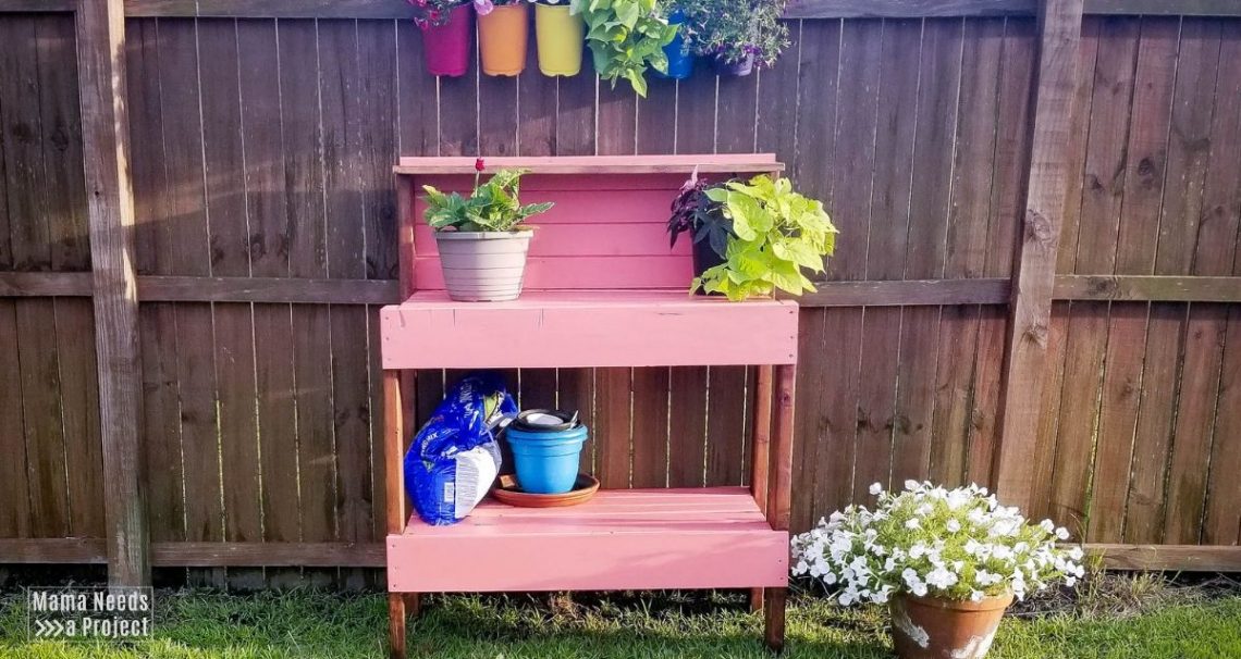 pink potting bench with flowers