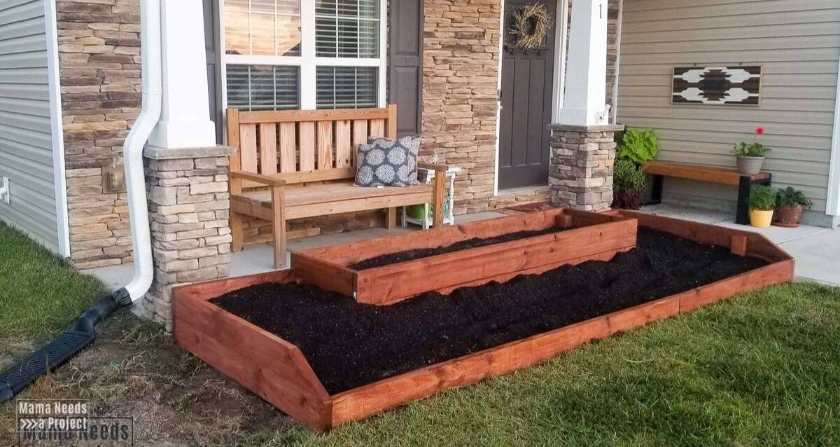wood raised flower bed on front of home