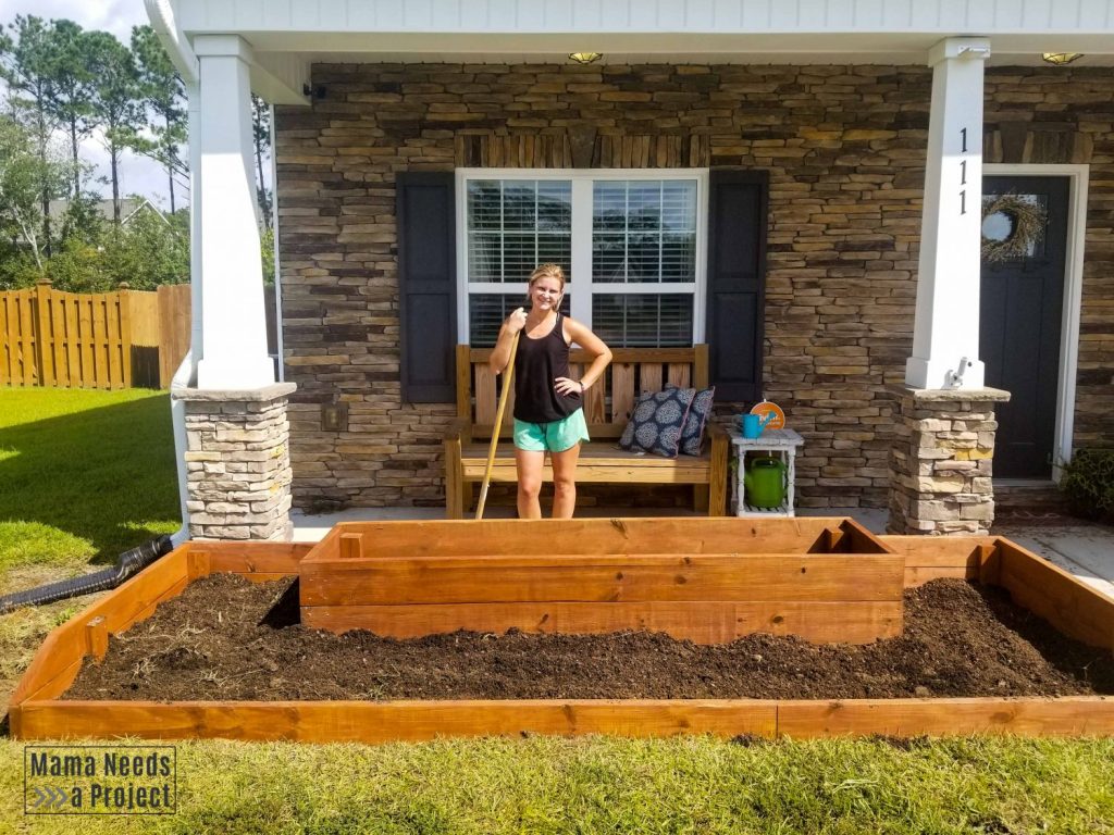 wood raised flower bed in front of house