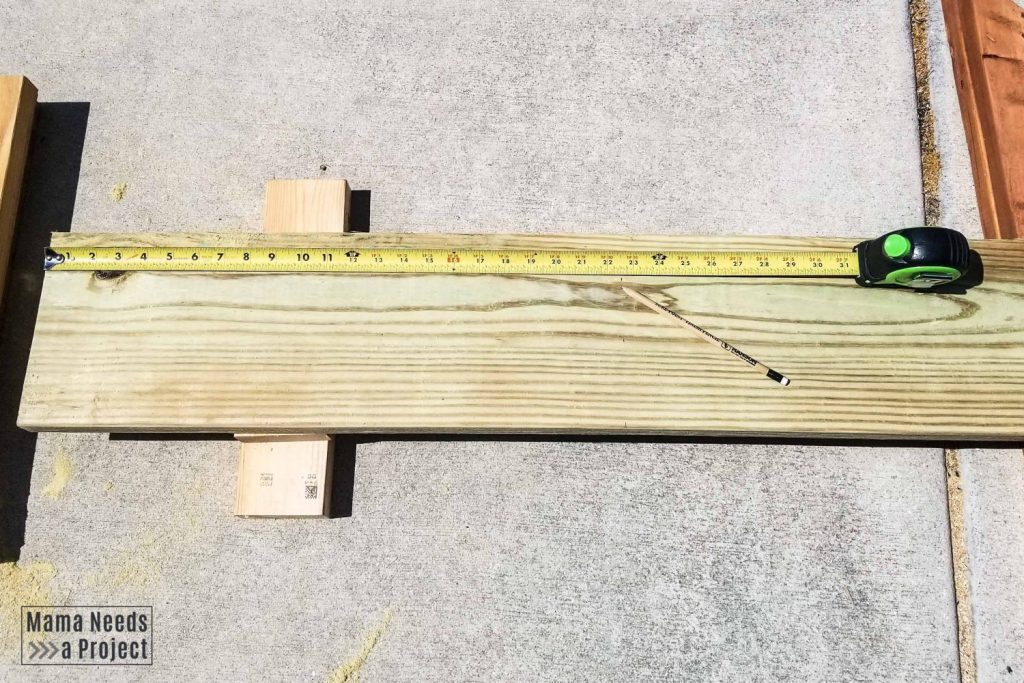 measuring wood, 2x8 board with a tape measure and pencil