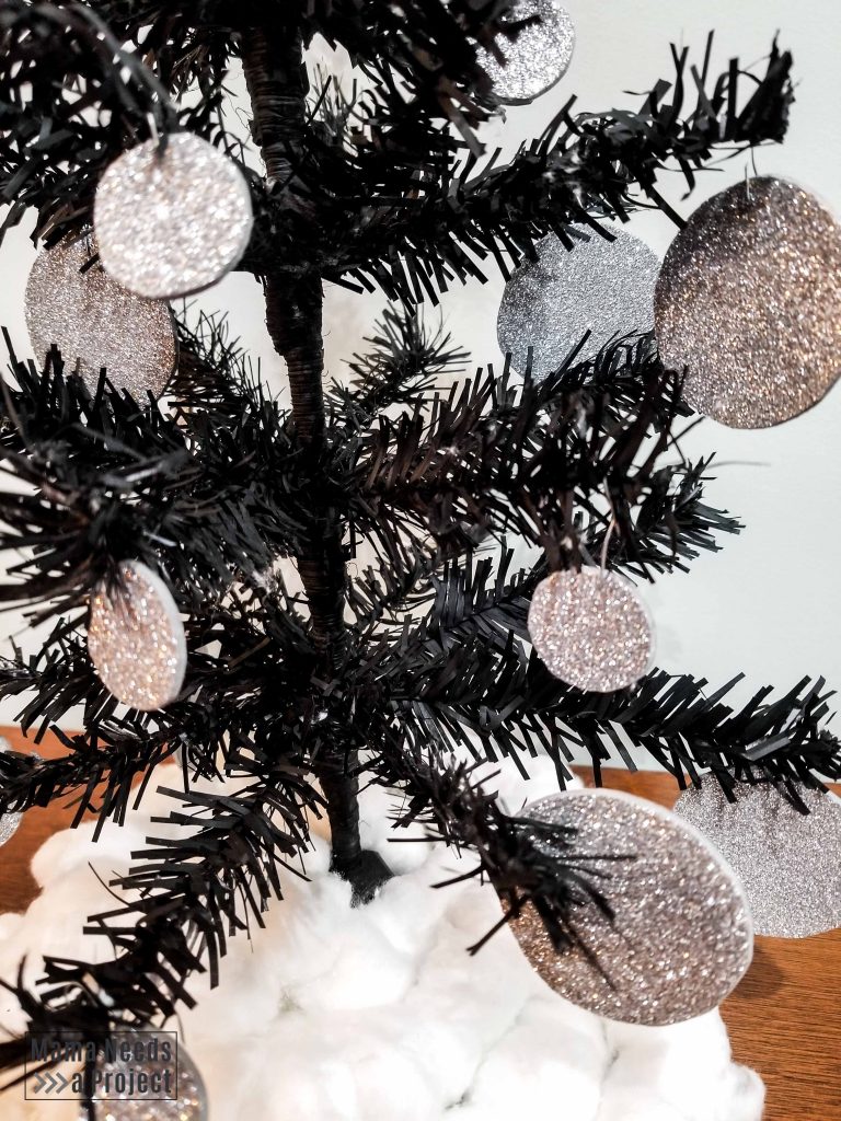 close up of glitter ornaments for black diy mini christmas tree