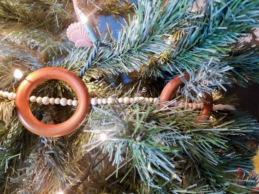 wood bead and ring christmas tree garland on a christmas tree