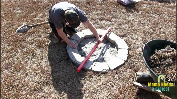 checking for level with a long level on diy fire pit