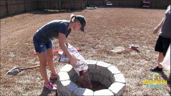 pouring lava rock into diy stone fire pit