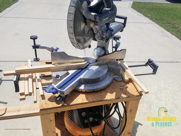 miter saw set to a 45 degree angle with strips of wood on it