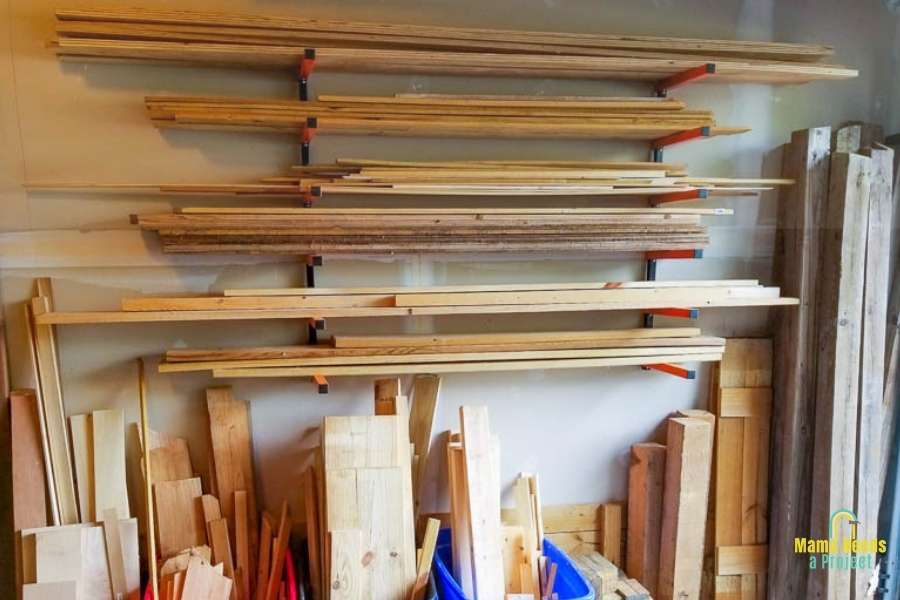 lumber storage rack on garage wall with lumber