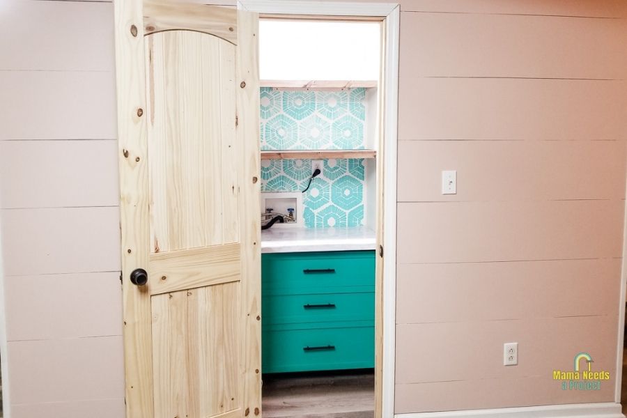 DIY small closet pantry with green drawers and a blue stenciled wall
