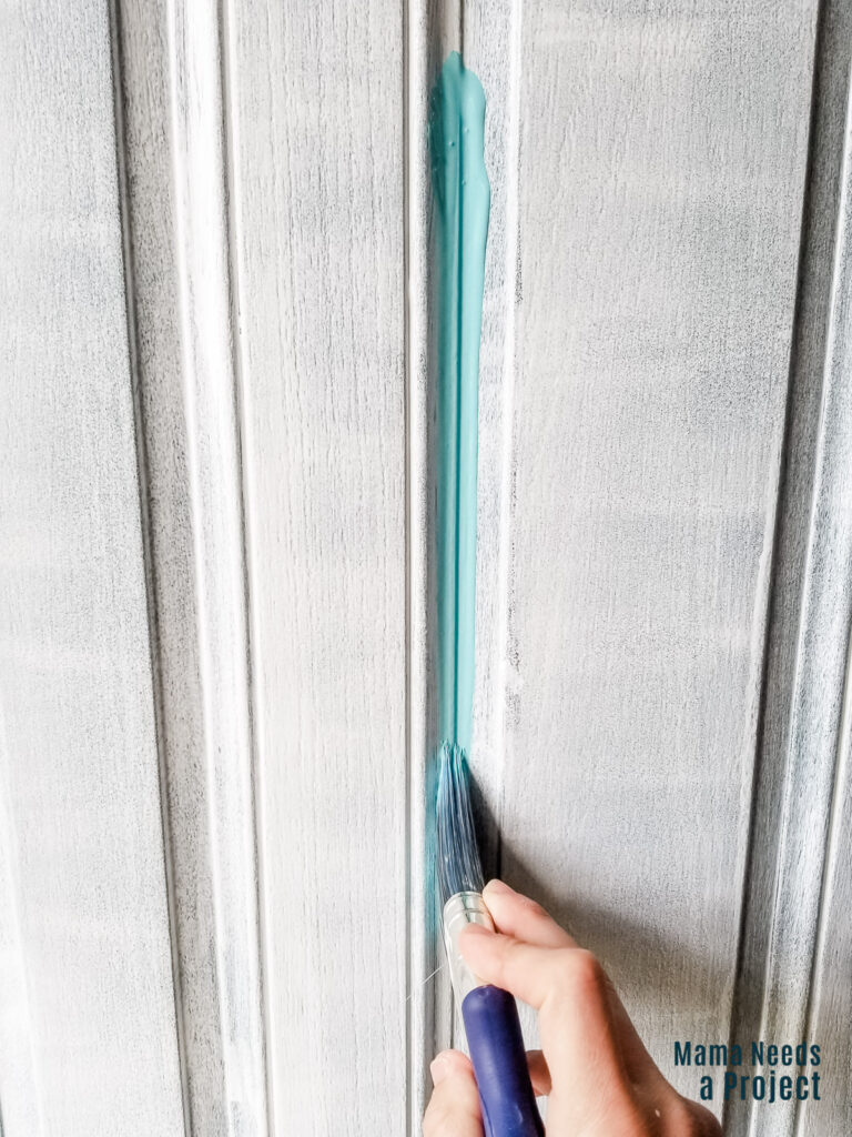 painting front door with a small angled paint brush