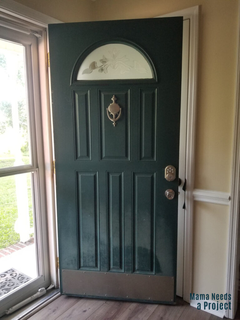 forest green front door with faded paint
